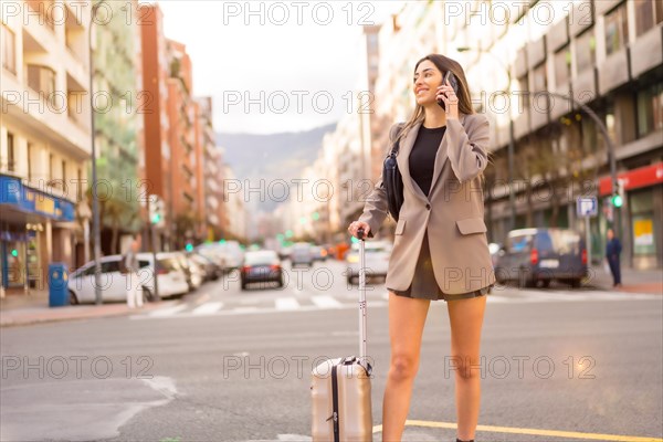 Tourist woman with suitcase in the city