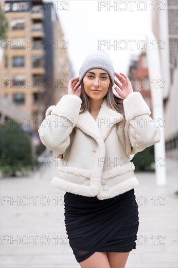 Winter portrait of a caucasian woman in a wool hat in the city