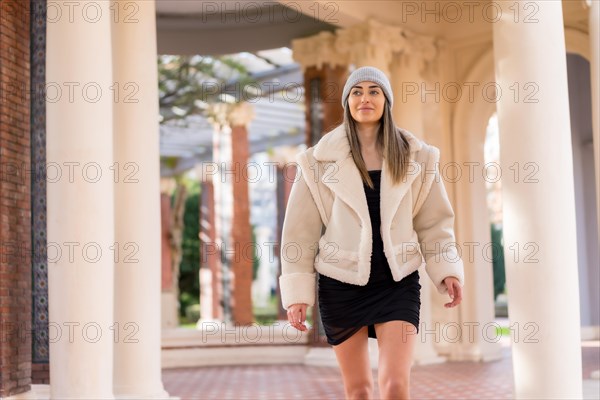 Woman with wool hat visiting a city park