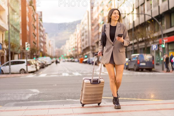 Tourist woman with suitcase in the city