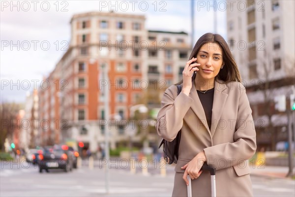 Portrait of tourist woman with suitcase on vacation in the city