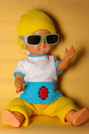 Cool doll with sunglasses and yellow knitted cap