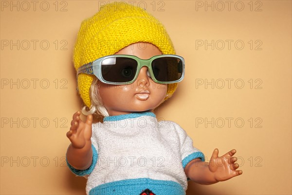 Cool doll with sunglasses and yellow knitted cap