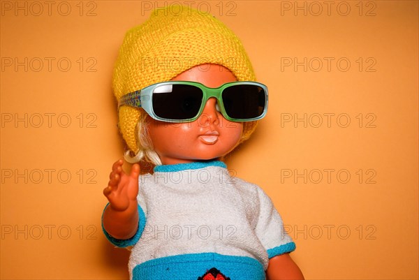 Cool doll with sunglasses and yellow knitted cap