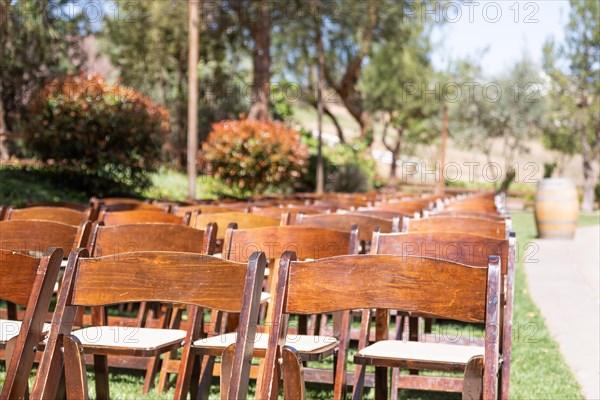 Rows of wooden event chairs at wedding venue abstract