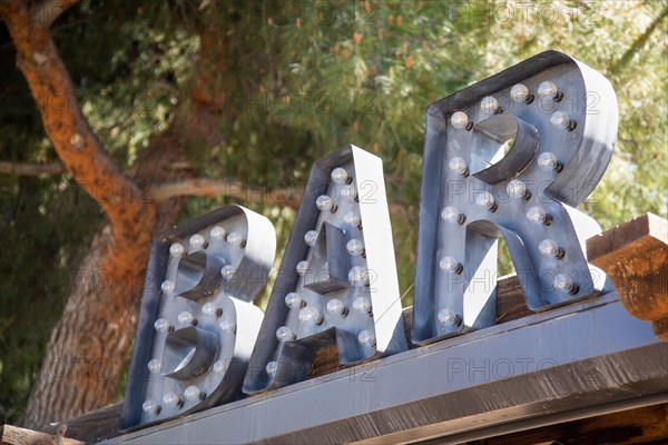 Industrial marquee letters bar sign with bulbs on roof of business