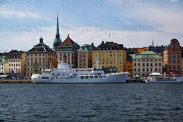 Excursion boats in front of old town houses in Gamla Stan district