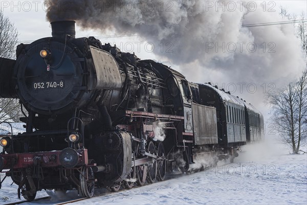 Steam train of the Swabian Alb Railway with steam locomotive 052740-8 on the line between Muensingen and Engstingen