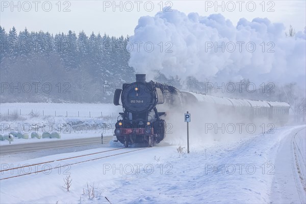 Steam train of the Swabian Alb Railway with steam locomotive 052740-8 on the line between Muensingen and Engstingen