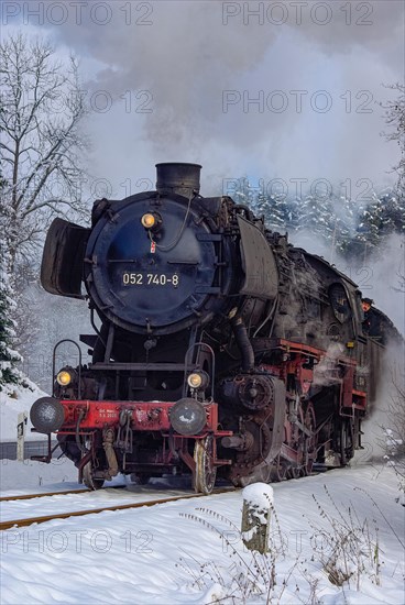 Steam train of the Swabian Alb Railway with steam locomotive 052740-8 on the line between Muensingen and Engstingen