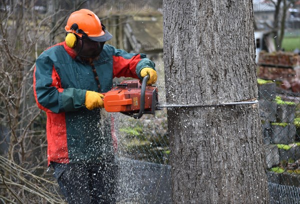 Worker with safety helmet and headphones