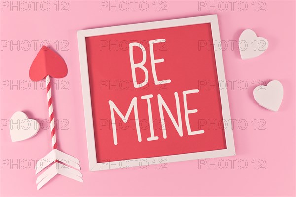 Valentines Day composition with picture frame with text Be Mine