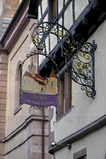 Cast iron sign on a house in Riquewihr