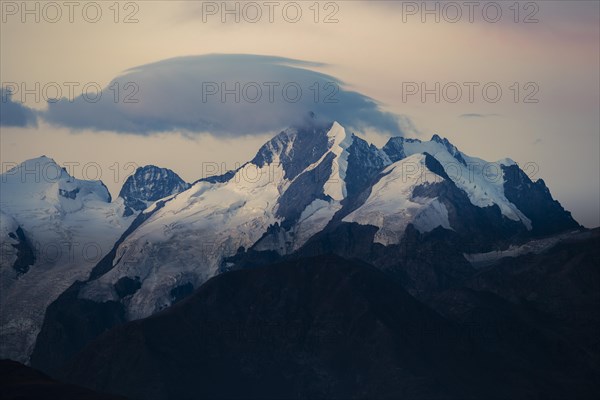 Summit of the Bernina Group with dramatic cloudy sky