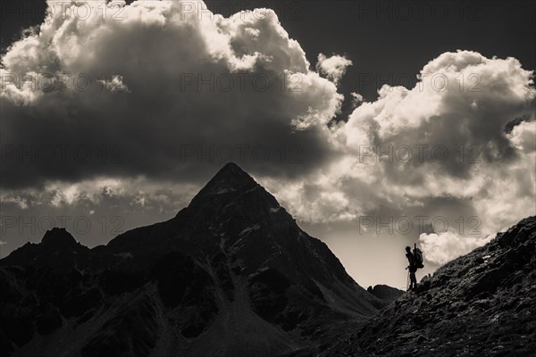 Striking peak of Piz OT with climber in the backlight