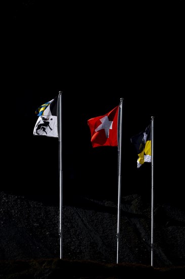 Swiss flags against a black background