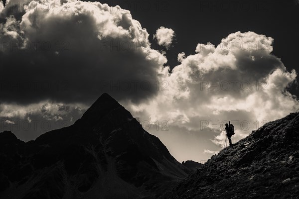 Striking peak of Piz OT with climber in the backlight