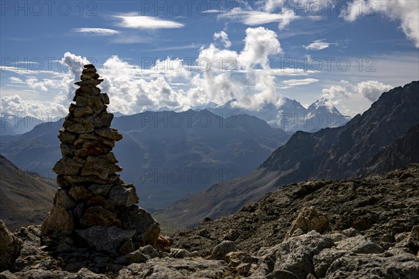 Cairn with Engadine Mountains and Cloudy Sky