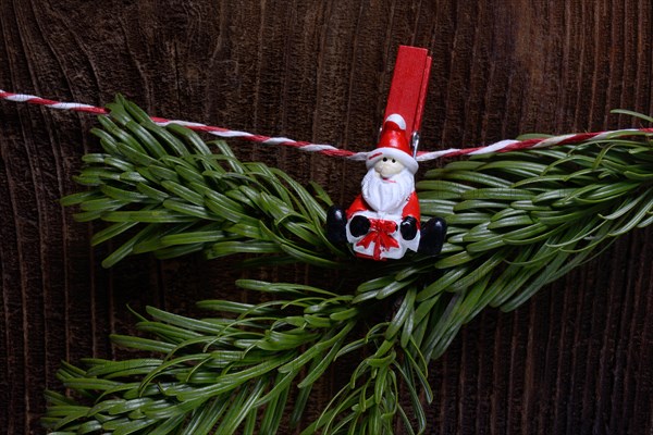 Clamp with Father Christmas holding fir greenery