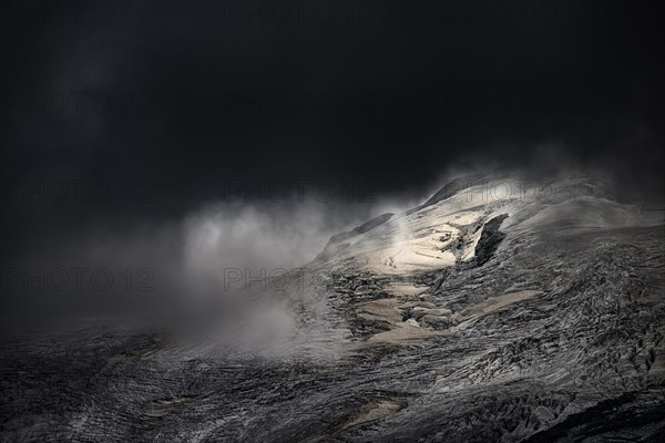 Bernina Group with Rosegg Glacier and dramatic clouds at blue hour