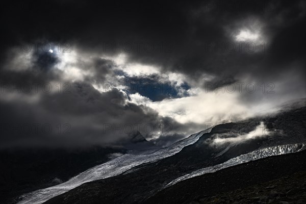 Bernina Group with Rosegg Glacier and dramatic clouds at blue hour