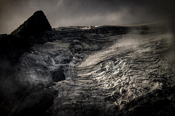 Bernina Group with Rosegg Glacier and dramatic clouds at blue hour