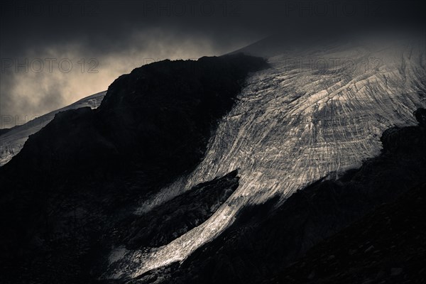 Bernina Group with Rosegg Glacier and dramatic clouds at blue hour
