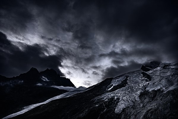 Bernina Group with Rosegg Glacier and dramatic clouds at blue hour