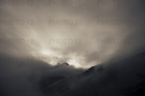 Bernina Group with Rosegg Glacier and dramatic clouds at blue hour