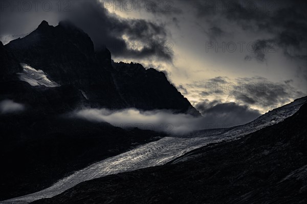 Bernina Group with Rosegg Glacier and dramatic clouds at blue hour