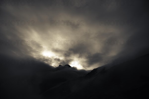 Bernina Group with Rosegg Glacier and dramatic clouds at blue hour