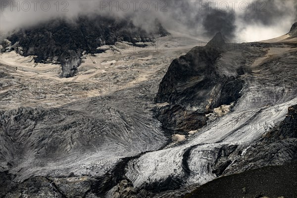 Bernina Group with Rosegg Glacier and dramatic clouds at blue hour