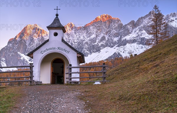 Chapel in front of mountain panorama in autumn