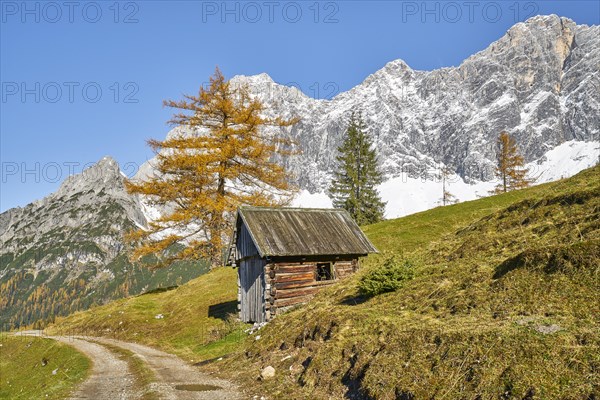 Hay barn in front of mountain scenery in autumn