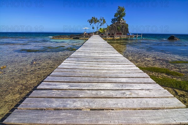 Pier to little islet on the coastline of the Island Ile Sainte Marie