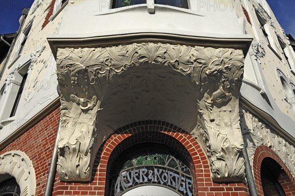 Entrance to a house and underside of a bay window with Art Nouveau elements around 1900
