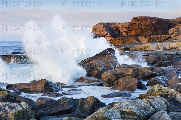 Water dashing against rocks on the rocky coast on Isle of Skye
