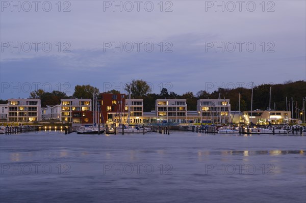 Marina and illuminated modern buildings at Priwall