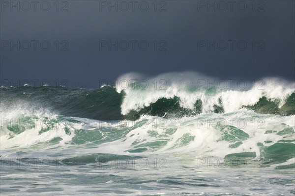 Big waves crashing in the open sea and dramatic light off the north coast of Ireland