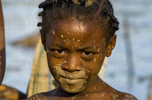 Dirty girl in a shallow lake