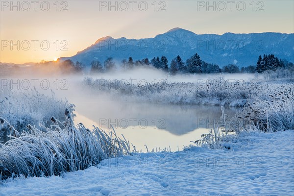 Snowy winter landscape with the Uffinger Ach at sunrise with Herzogstand 1731m and Heimgarten 1790m