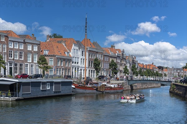 Cityscape with houseboat and traditional flat-bottomed sailing boat at Bierkaai
