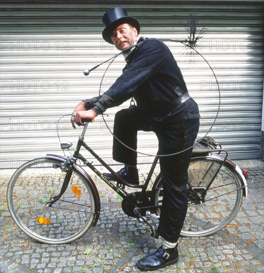 Chimney sweep in professional training and posing in a photo studio