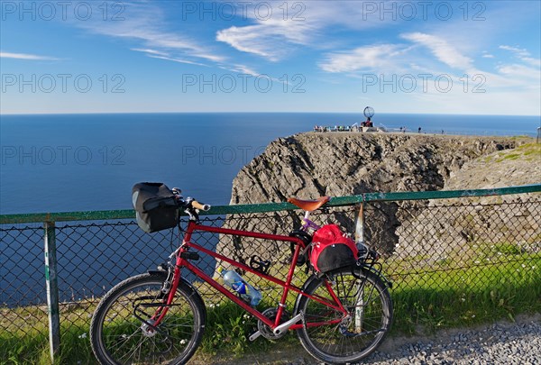 Mountain bike leaning against a fence