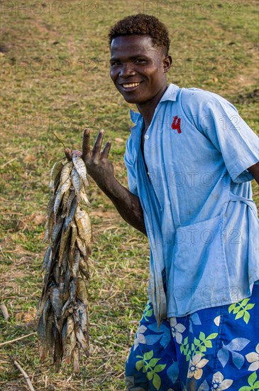 Proud boy presenting his fresh caught fish