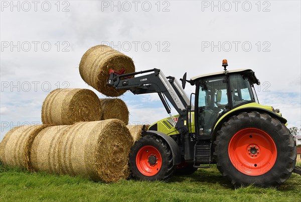 Tractor with bale fork stacking round bales