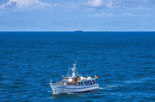 The motor yacht Merkur II returns from a burial at sea and enters the home port of Rostock-Warnemuende