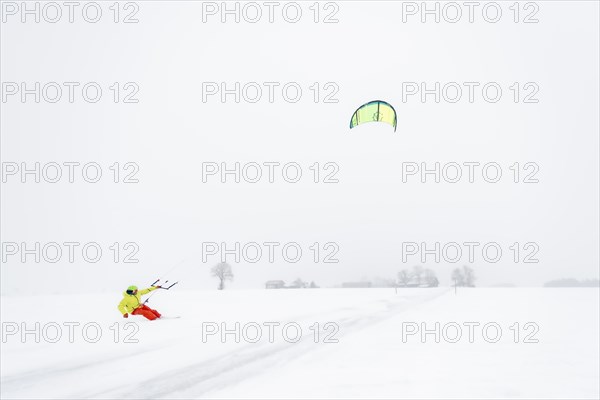 Kite surfers in wintry landscape