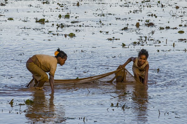 Locals fishing in a shallow lake