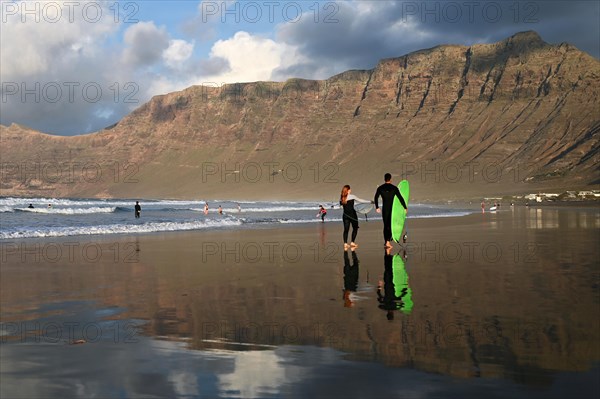 Surfers on the beach of Caleta de Famara